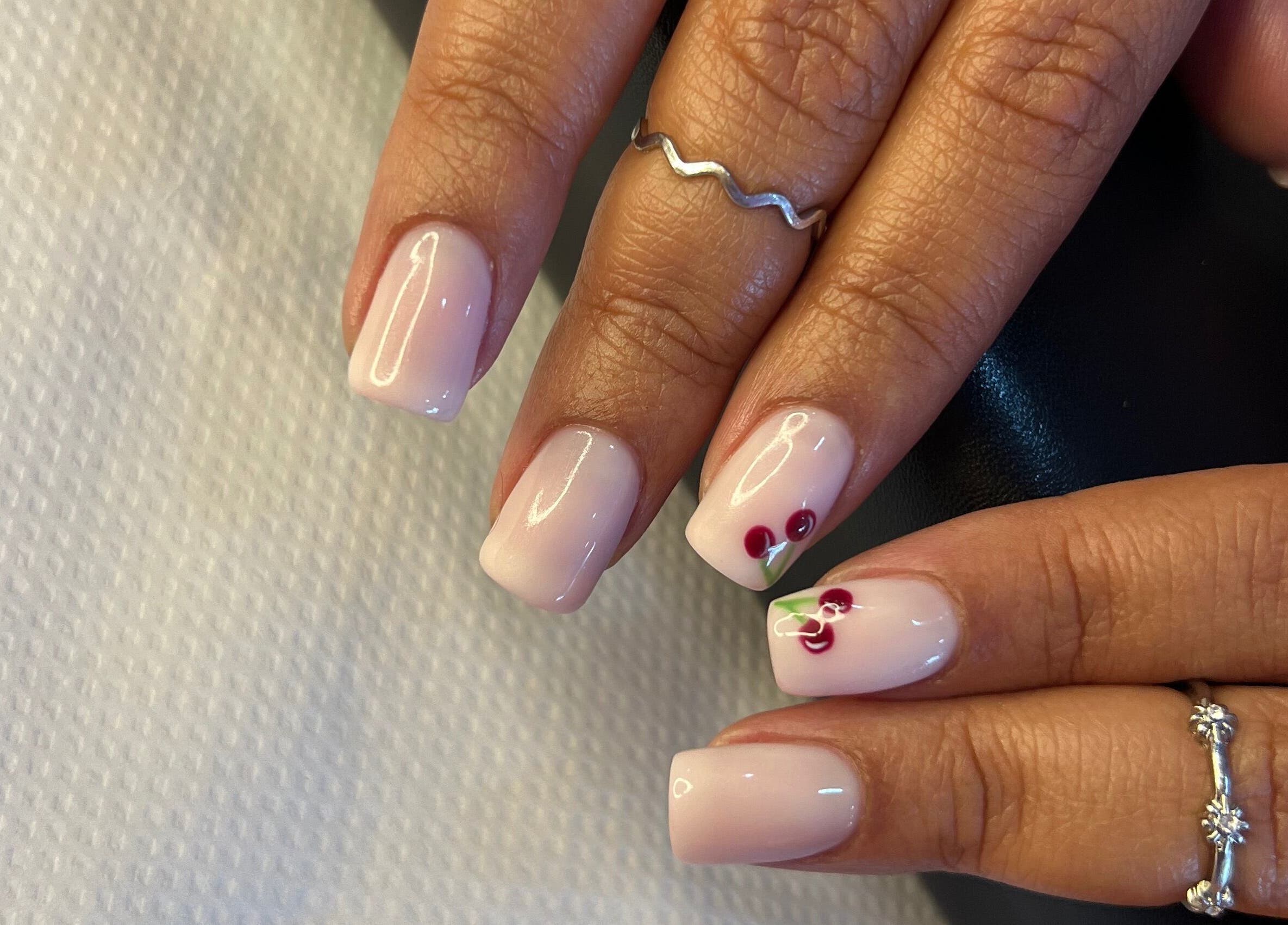Elegant nail art at ROZÏÏ JŪ in East London, Eastern Cape, ZA, featuring delicate cherry designs.