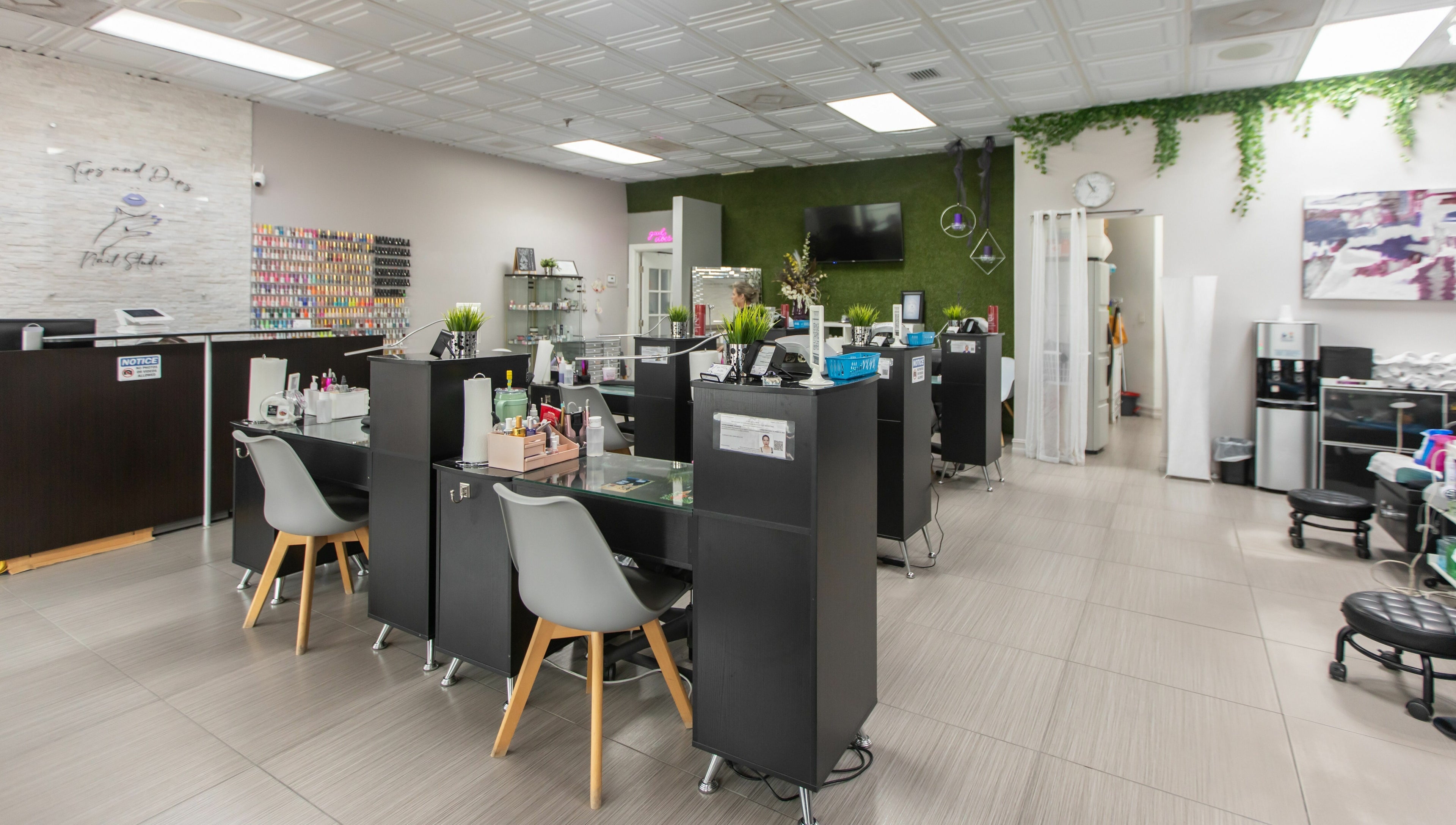 Modern interior of Tips & Dips Nail Studio in Doral, Florida, US, showcasing stylish nail bar setup.