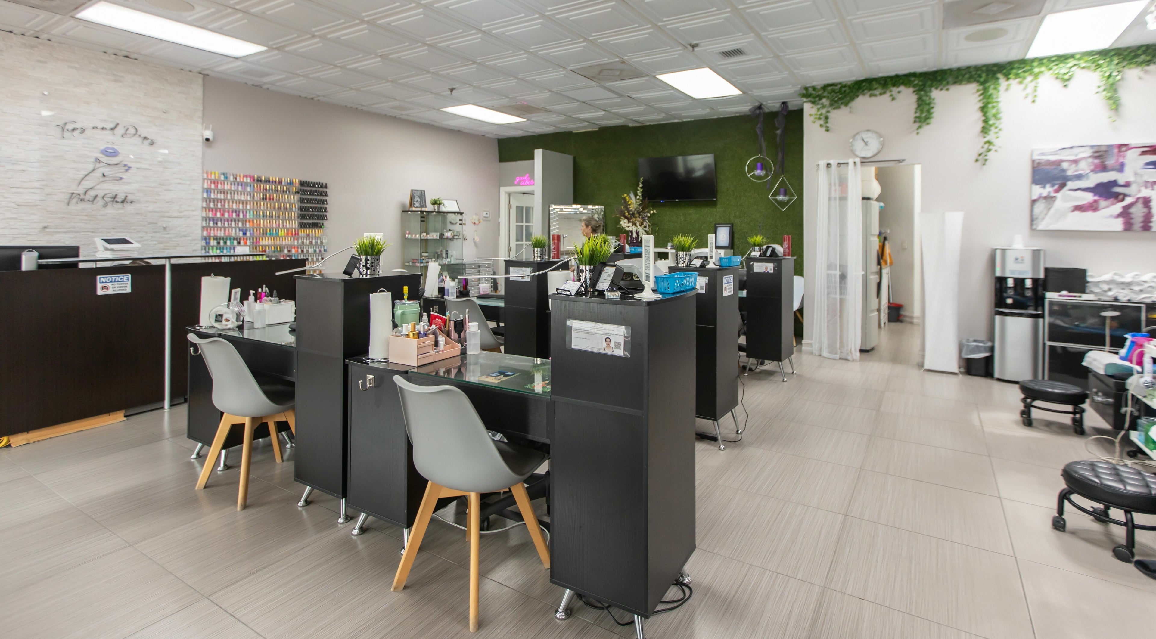 Modern interior of Tips & Dips Nail Studio in Doral, Florida, US, showcasing stylish nail bar setup.
