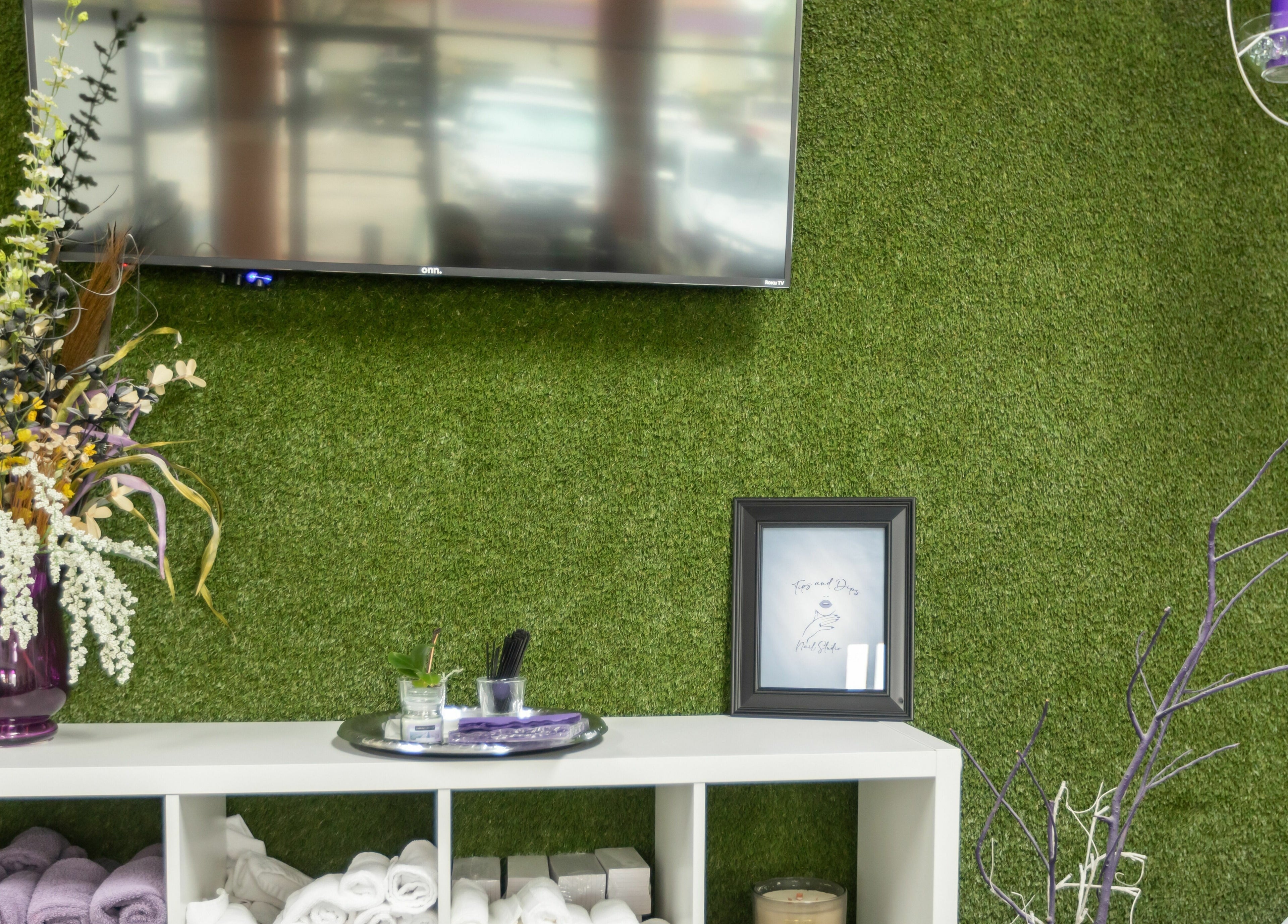 Chic decor at Tips & Dips Nail Studio with green wall in Doral, Florida, US.