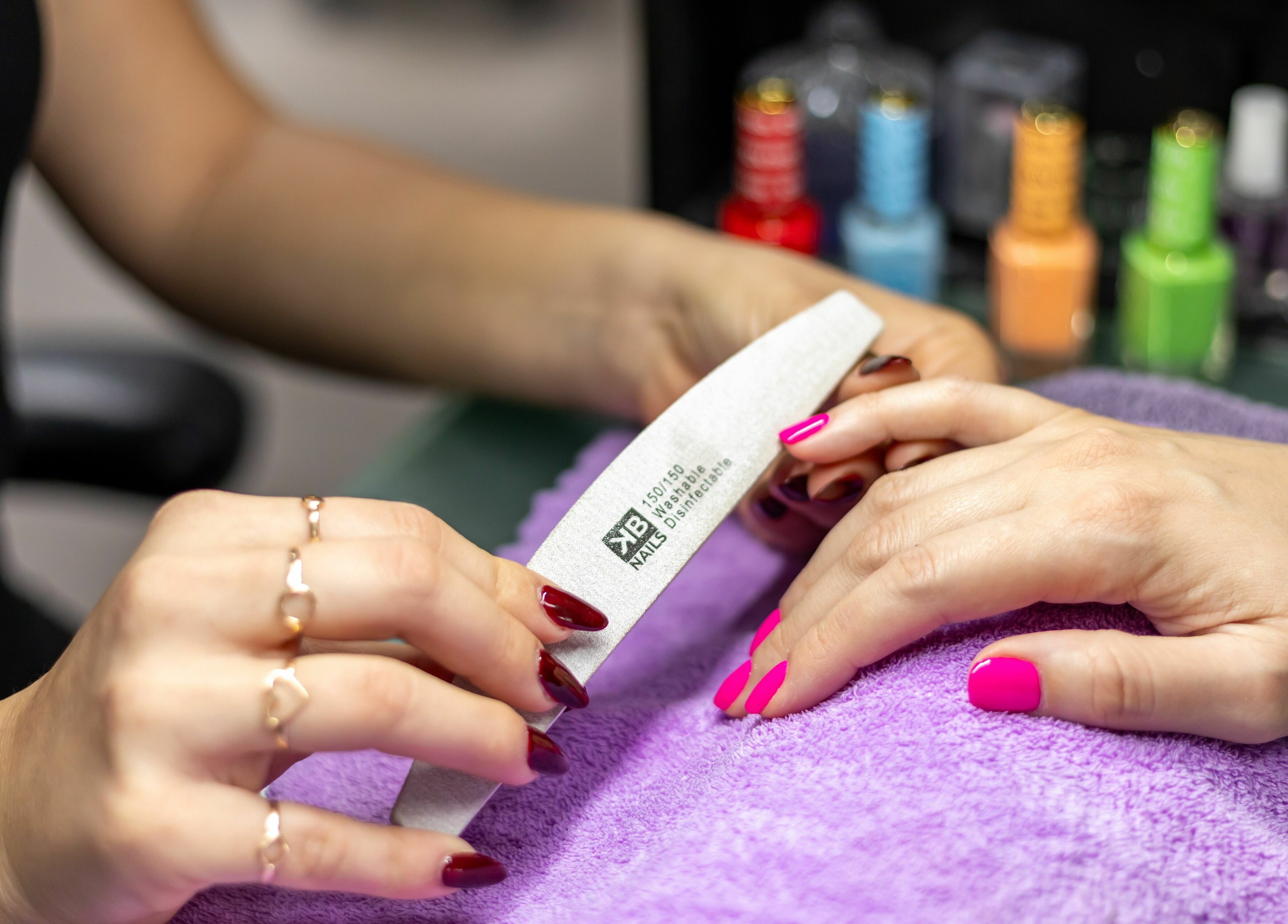 Manicure session at Tips & Dips Nail Studio, Doral, Florida, US, highlighting a vibrant nail care service.