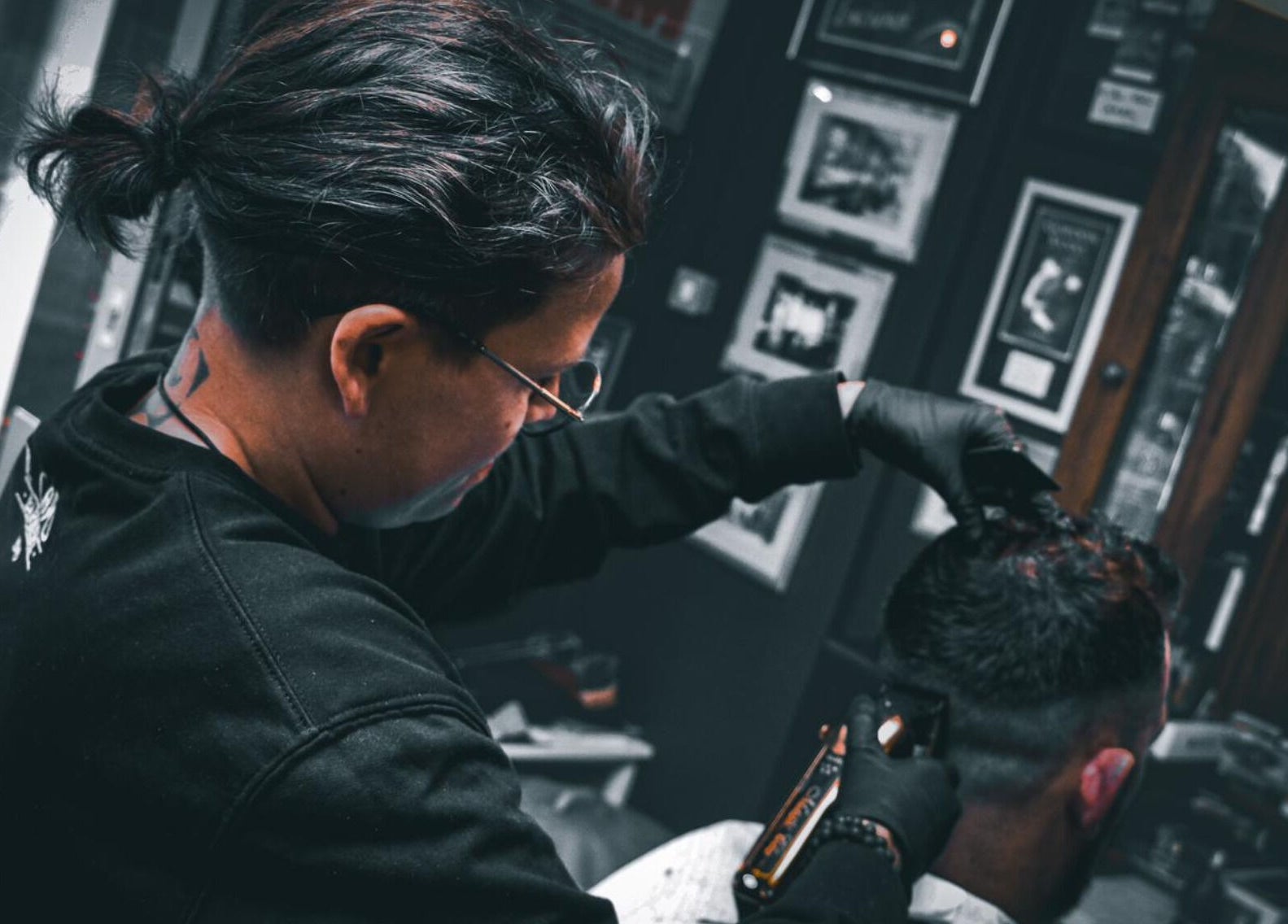 Stylist at Il Capo Barbiere in Newcastle-under-Lyme, England, GB, skillfully trims a client's hair.