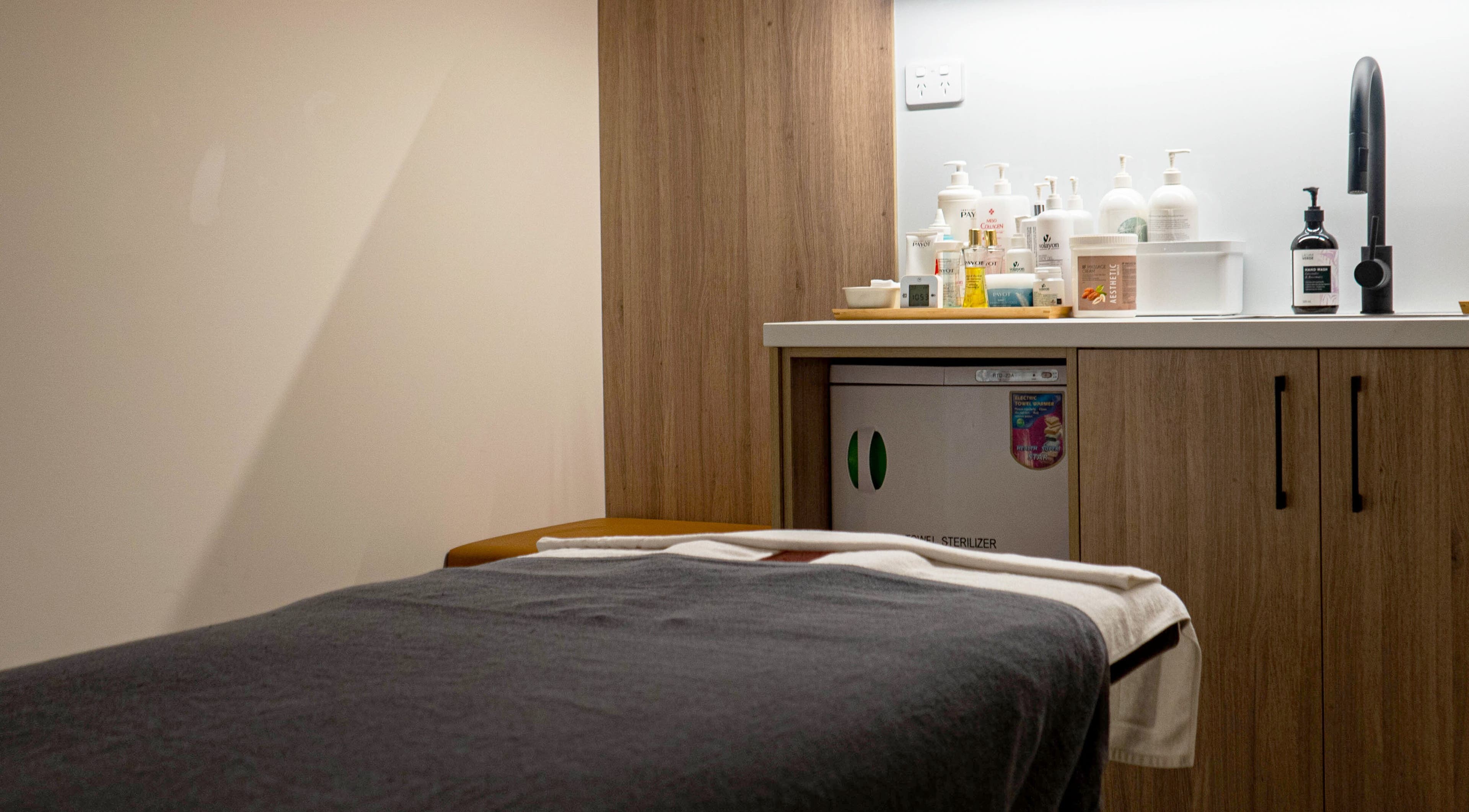 Tranquil spa room at Kim's Healthcare Clinic, Strathfield, New South Wales, AU with treatment table and products.