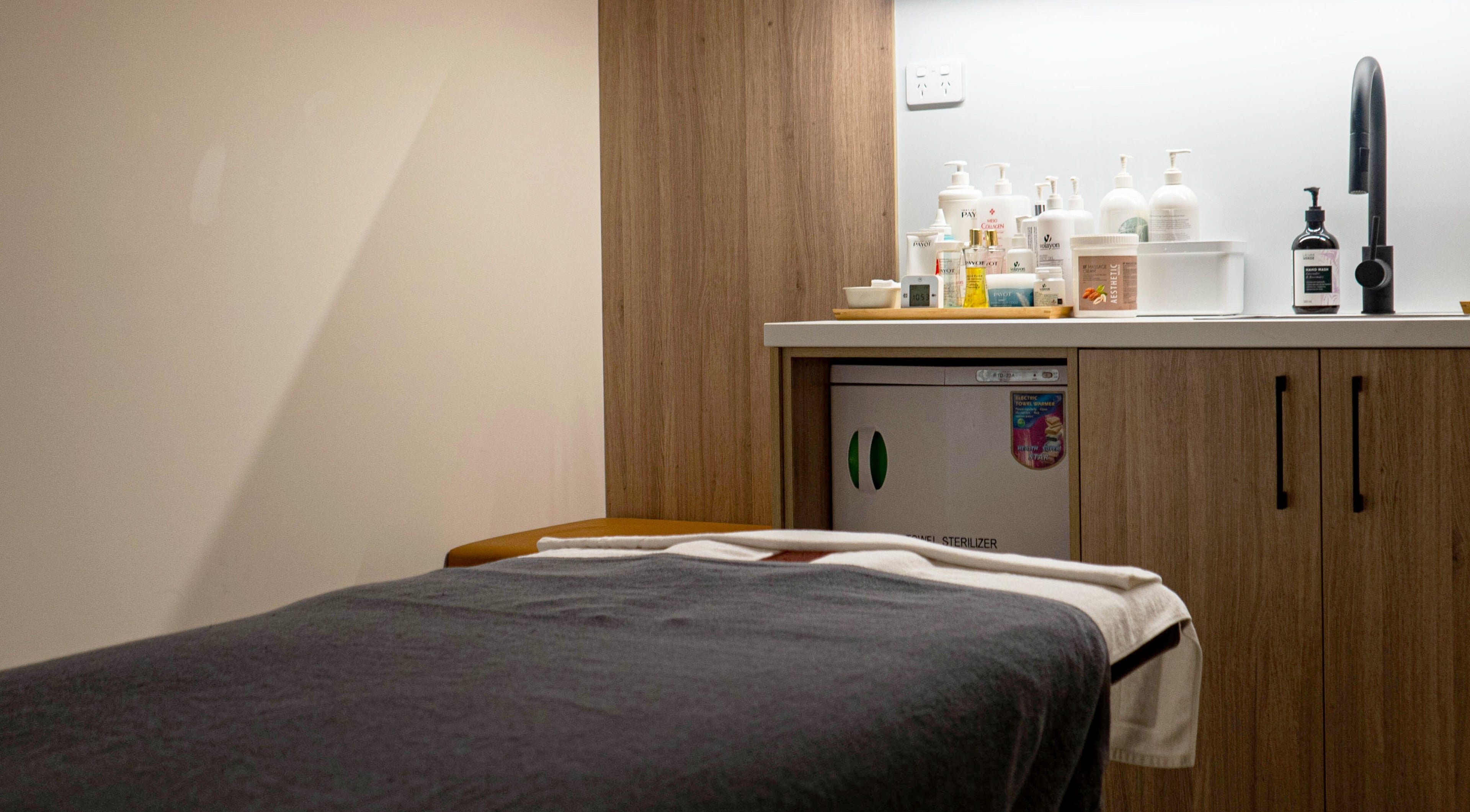 Tranquil spa room at Kim's Healthcare Clinic, Strathfield, New South Wales, AU with treatment table and products.