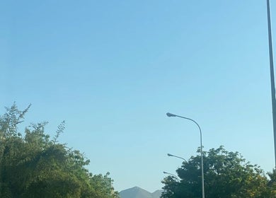 View of clear blue sky over green trees near Tina magic | Home Service Muscat, Muscat, Muscat Governorate, OM.