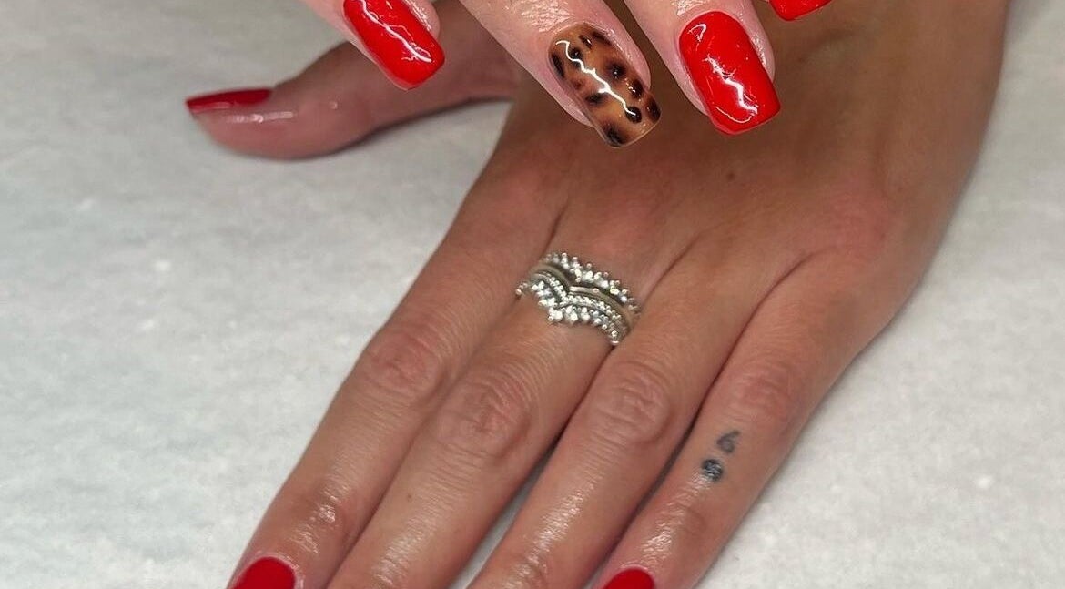 Red and leopard nail art showcasing elegant style at Evoke Beauty, Yate, England, GB.