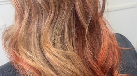 Soft, wavy hair with warm tones styled at Kim A Hair, Masham, England, GB, showcasing professional coloring.