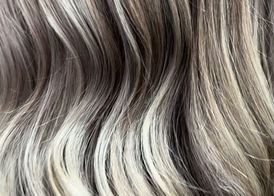 Close-up of shiny, highlighted hair at Kim A Hair, Masham, England, GB. Perfect blend of tones and smooth texture.