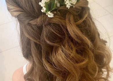 Intricate bridal hairstyle with floral accents at Kim A Hair, Masham, England, GB.