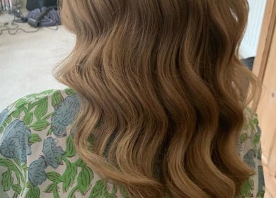 Luxurious wavy hairstyle at Kim A Hair, Masham, England, GB, showcasing expertly styled blonde curls.
