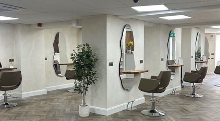 Elegant hair salon interior at Kim A Hair, Masham, England, GB featuring stylish mirrors and chairs.