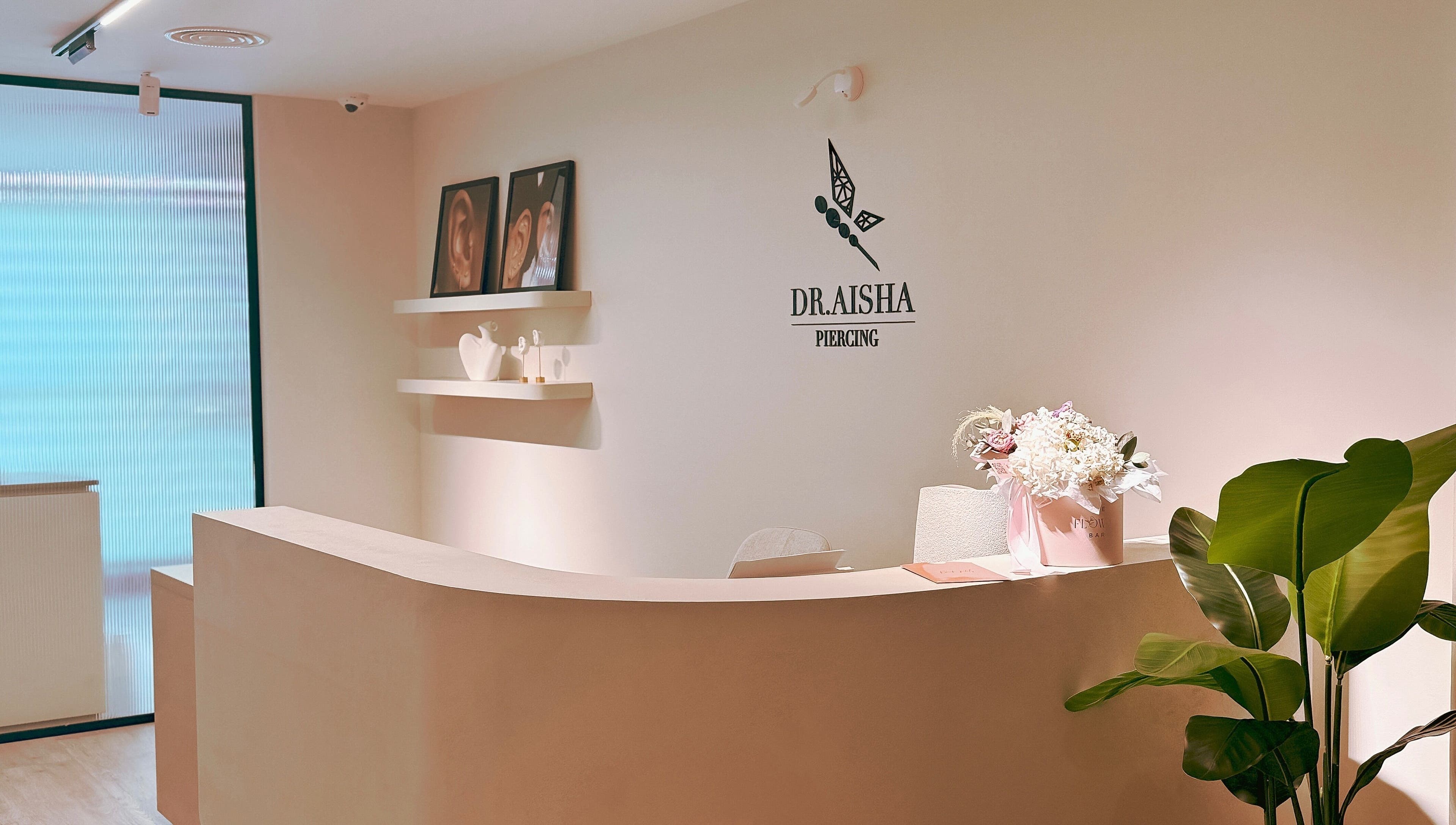 Elegant reception area at Dr. Aisha Piercing, Dubai, Dubai, AE with warm decor and floral accents.