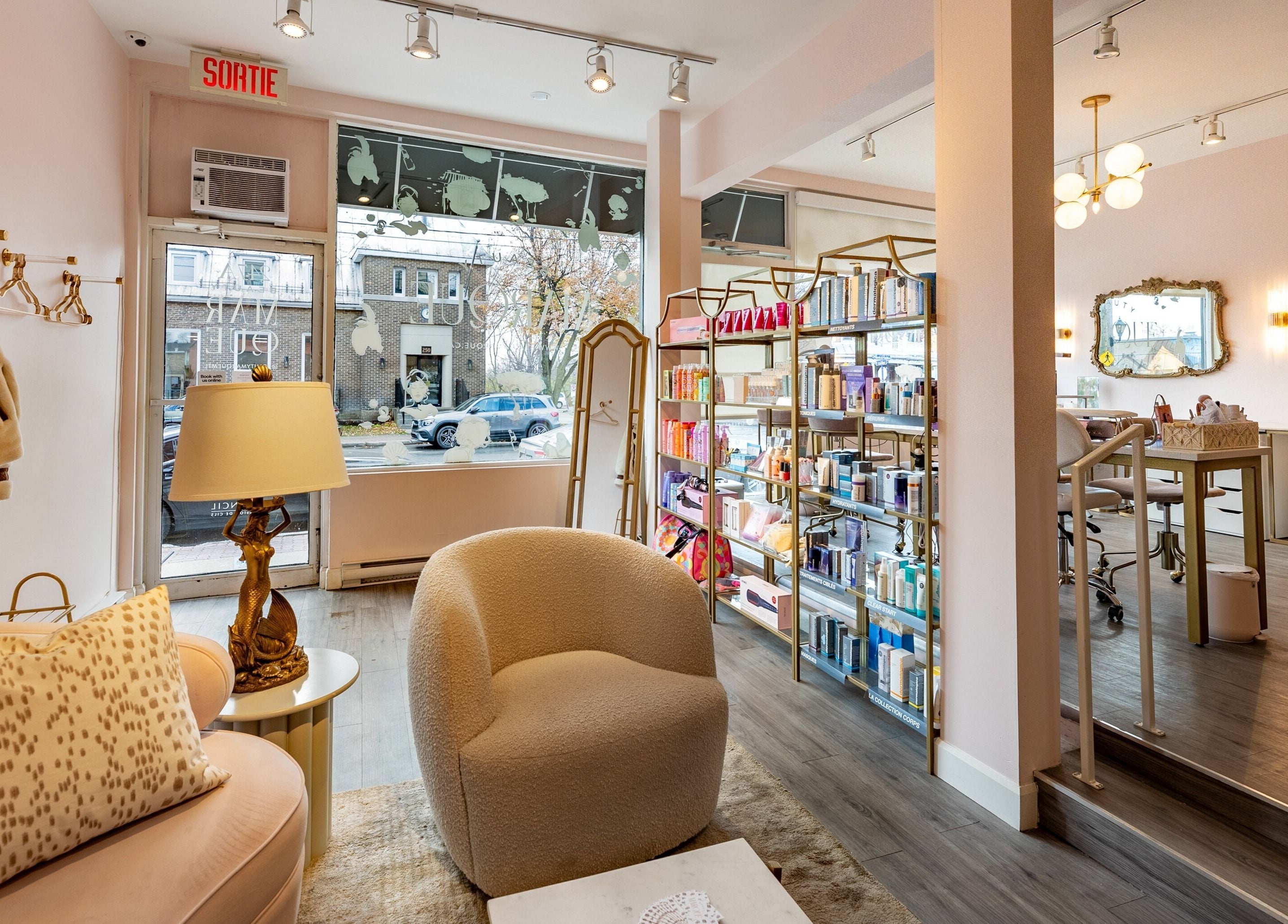 Elegant and welcoming interior of Beauty Marque, Pointe-Claire, Québec, CA featuring plush seating and curated products.