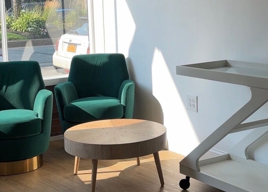 Elegant seating area with green chairs at Prado Beauty, Worcester, Massachusetts, US.