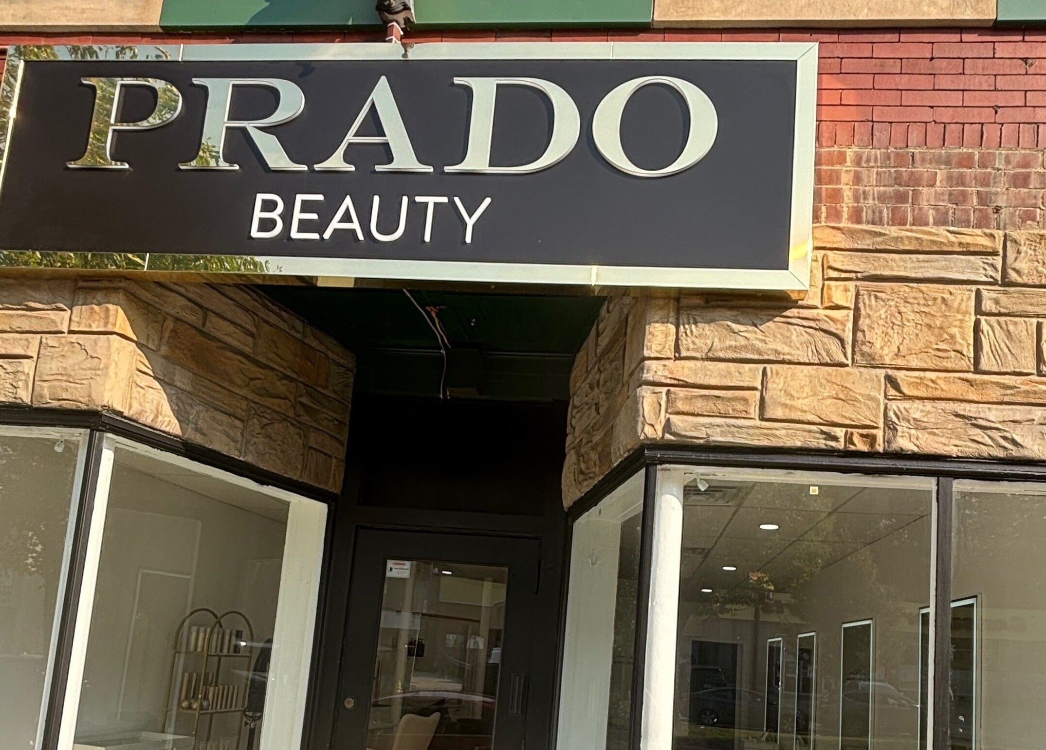 Front entrance with sign of Prado Beauty in Worcester, Massachusetts, US welcoming clients.