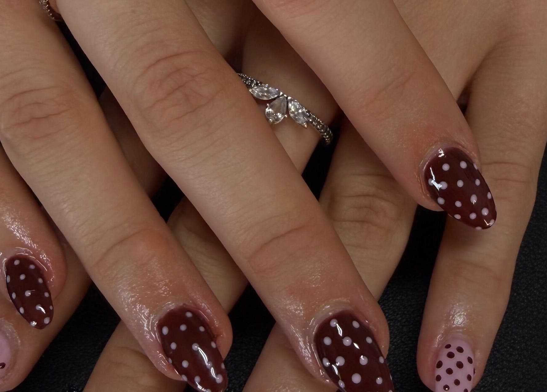 Polka dot nail art on hands at Dlux Beauty Bar, Laidley, Queensland, AU.