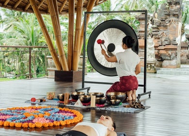 Gong session at Dirasha Wellness in Bali, Bali, ID surrounded by nature and colorful decor.
