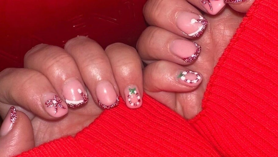 Festive nail art with red glitter and designs by Beauty By Poppy Marina in Bury, England, GB.