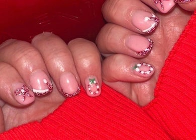 Festive nail art with red glitter and designs by Beauty By Poppy Marina in Bury, England, GB.