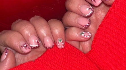 Festive nail art with red glitter and designs by Beauty By Poppy Marina in Bury, England, GB.
