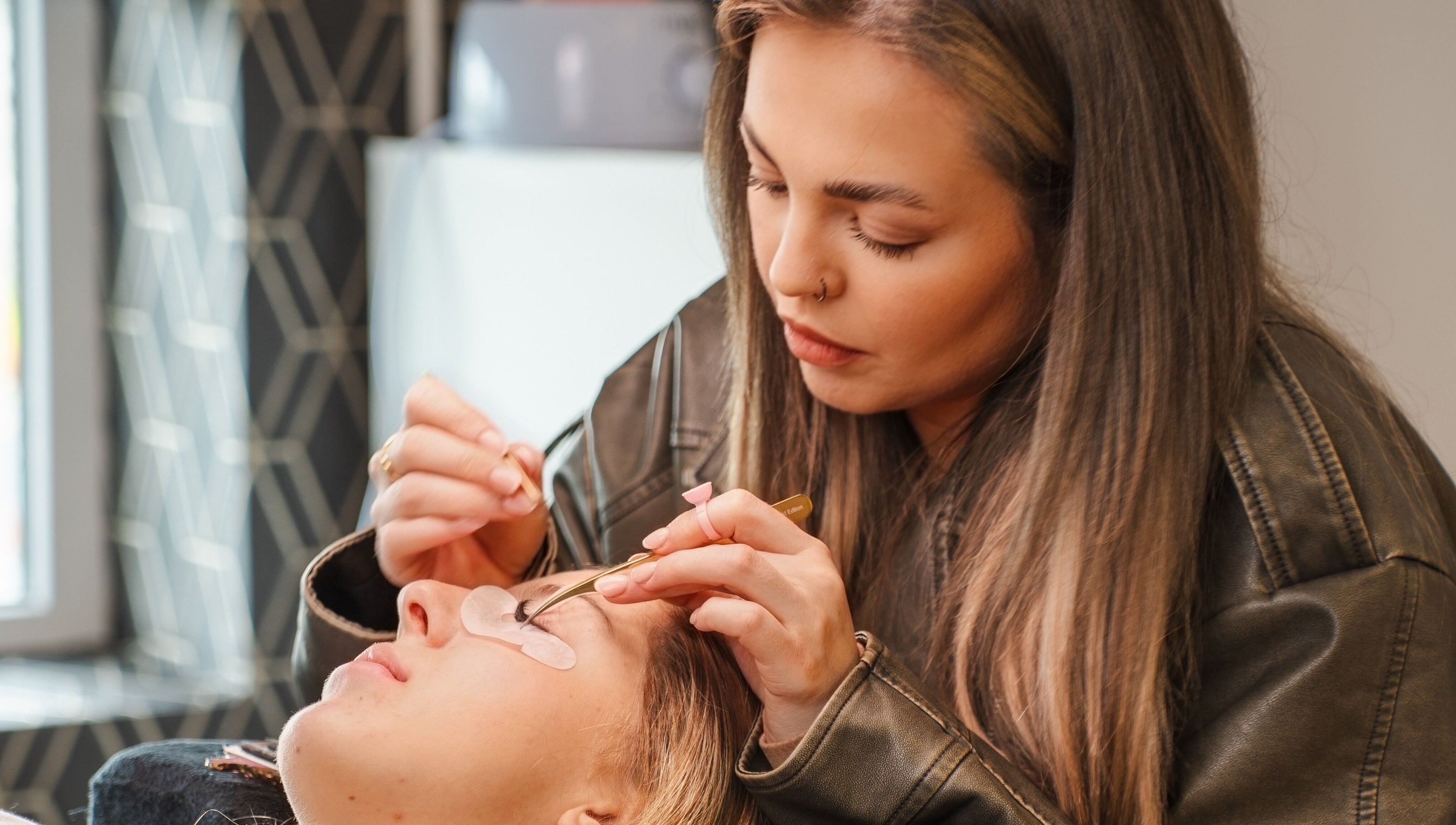 Lash technician at Eyeline, Gorey, County Wexford, IE, applying lash extensions with precision.
