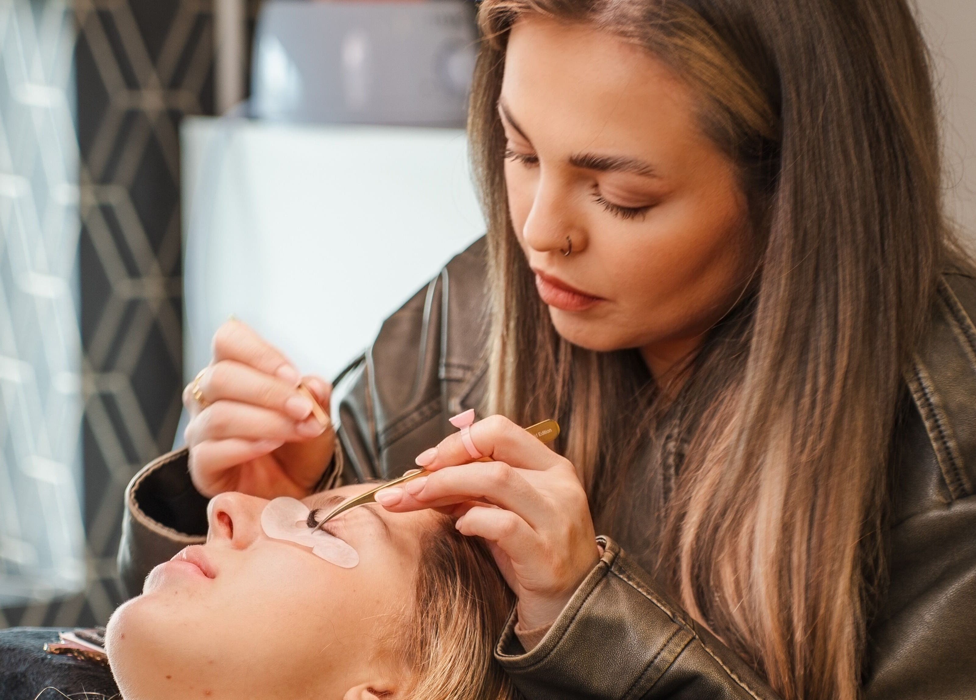Lash technician at Eyeline, Gorey, County Wexford, IE, applying lash extensions with precision.