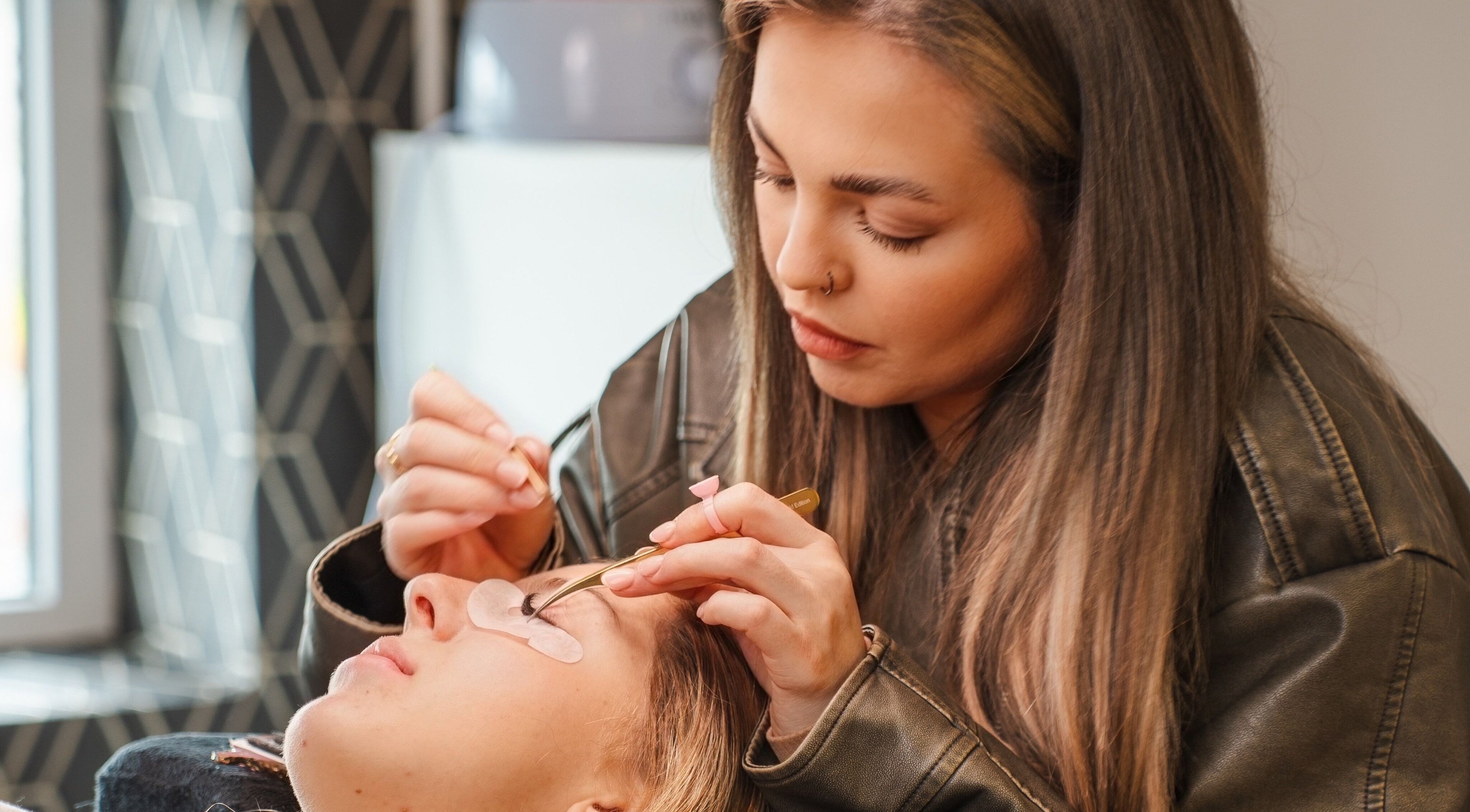 Lash technician at Eyeline, Gorey, County Wexford, IE, applying lash extensions with precision.