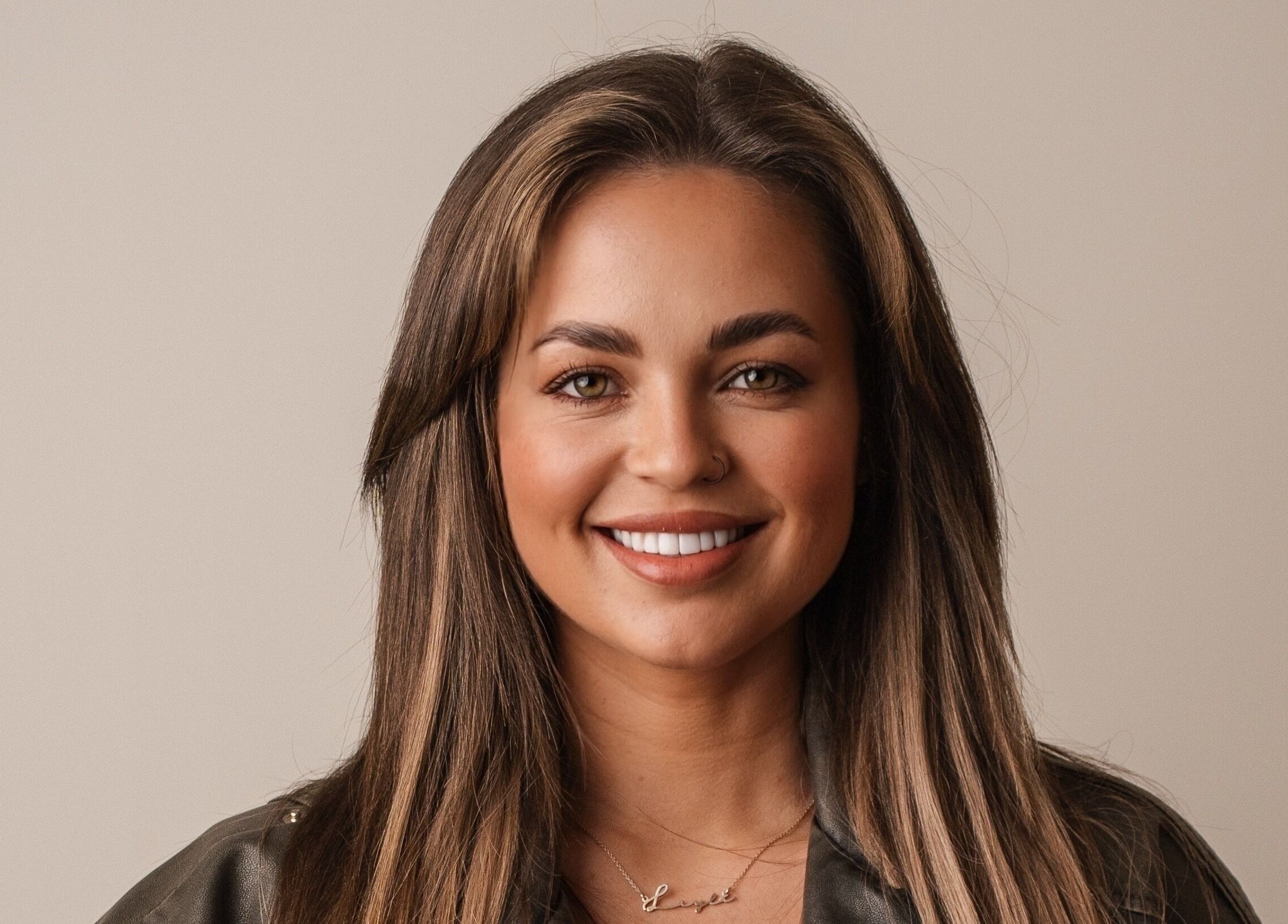 Woman smiling warmly, showcasing hairstyling at Eyeline, Gorey, County Wexford, IE.
