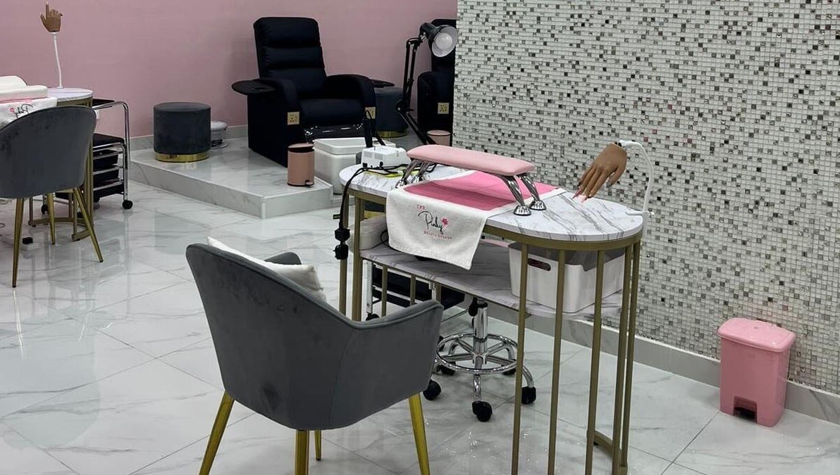 Elegant nail care station at The Pinky Beauty Lounge in Abu Dhabi, AE with plush seating and modern decor.