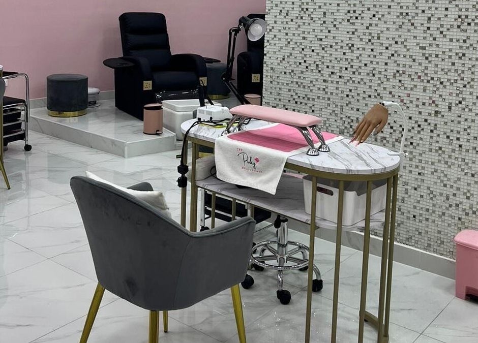 Elegant nail care station at The Pinky Beauty Lounge in Abu Dhabi, AE with plush seating and modern decor.