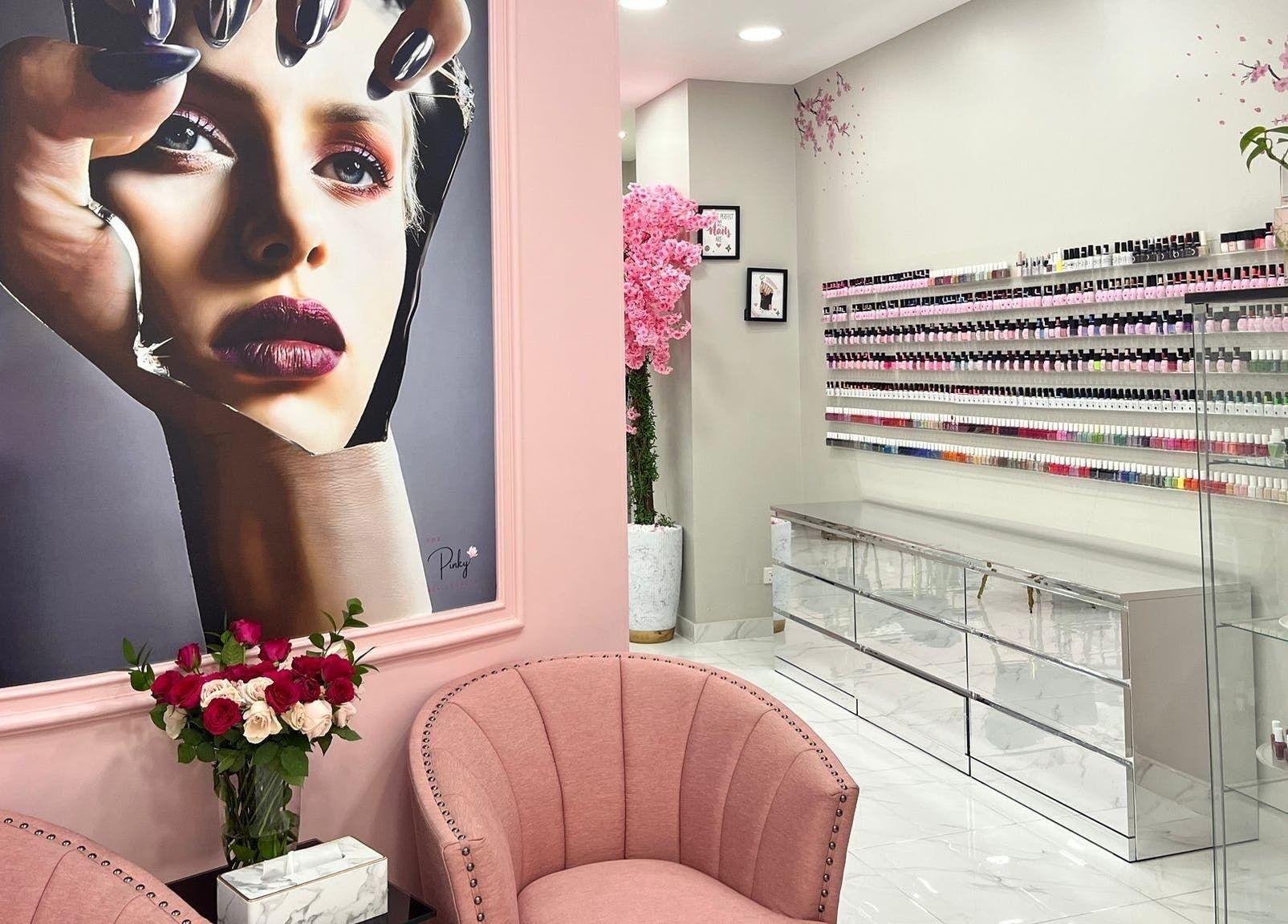 Chic interior of The Pinky Beauty Lounge, Abu Dhabi, AE, featuring plush seating and nail polish displays.