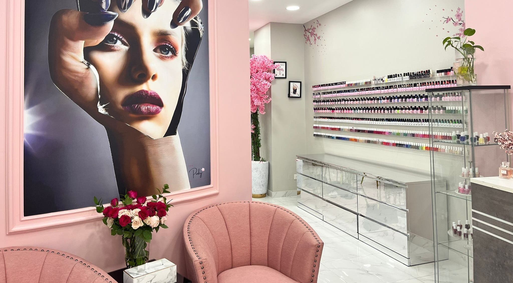 Chic interior of The Pinky Beauty Lounge, Abu Dhabi, AE, featuring plush seating and nail polish displays.