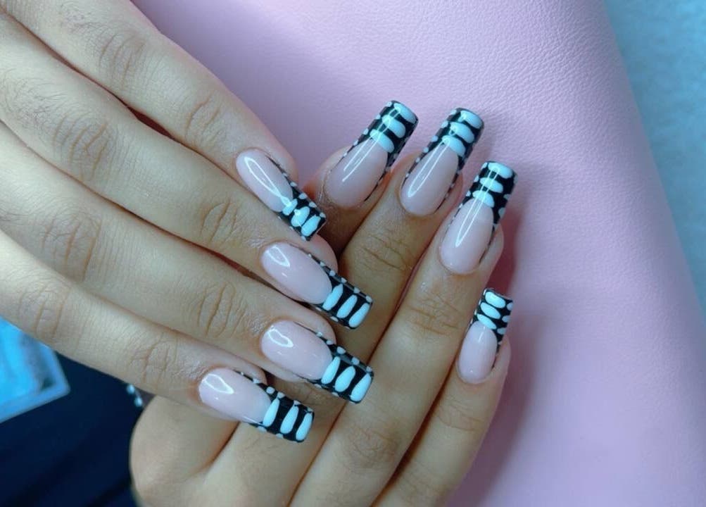 Stylish black and white nail design at The Pinky Beauty Lounge, Abu Dhabi, AE.