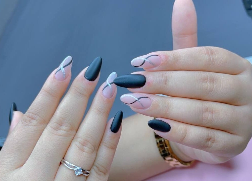 Chic black and silver nail design at The Pinky Beauty Lounge in Abu Dhabi, AE.