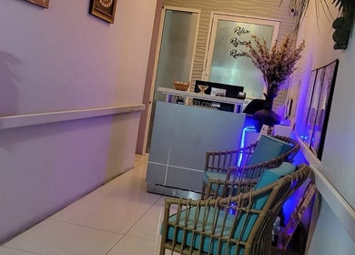 Welcoming entryway of L'Image Parfaite Day Spa in Port of Spain, TT with cozy seating and calming decor.