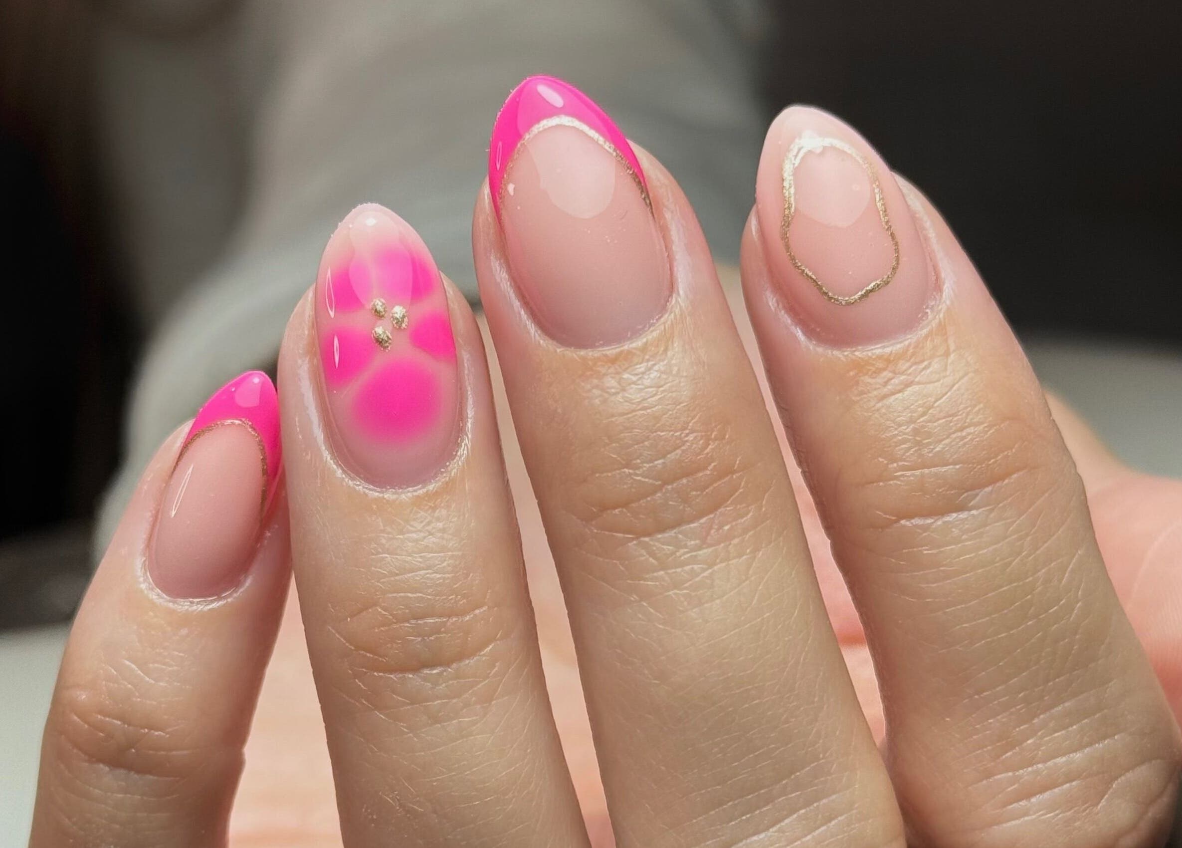 A vibrant pink and gold nail design showcased at Nailssby.han in Heywood, England, GB.