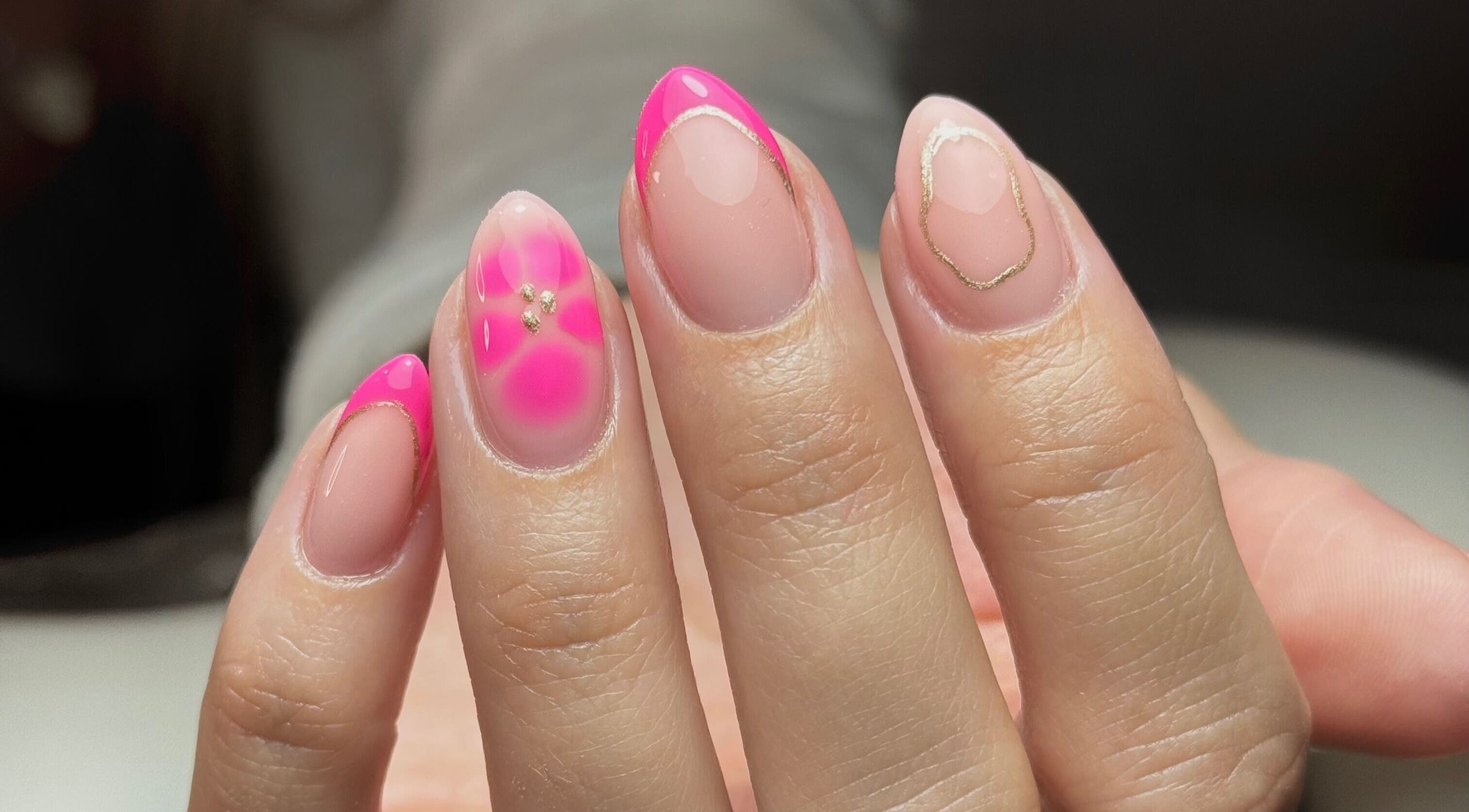 A vibrant pink and gold nail design showcased at Nailssby.han in Heywood, England, GB.