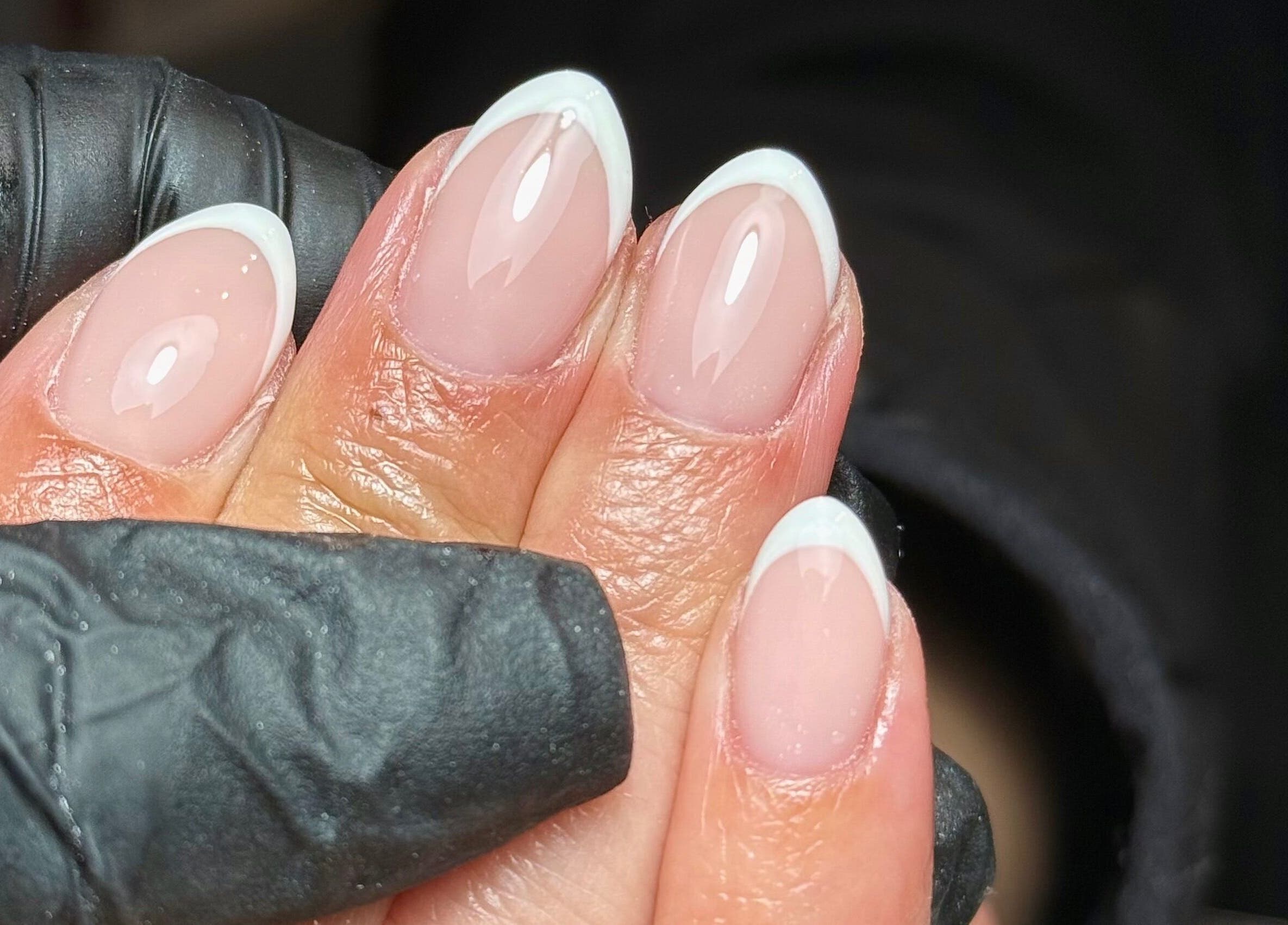 Elegant French manicure close-up at Nailssby.han in Heywood, England, GB. Expert nail art and care.