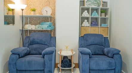 Cozy blue chairs in Chilax, DARWIN CITY, NT, AU. Perfectly designed for a relaxing beauty experience.