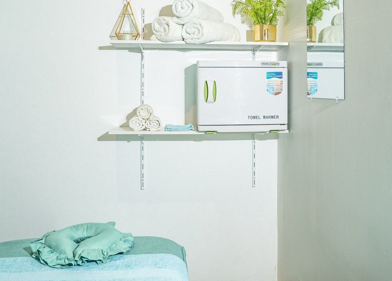 Relaxing treatment room at Chilax, DARWIN CITY, Northern Territory, AU, featuring fresh towels and a towel warmer.
