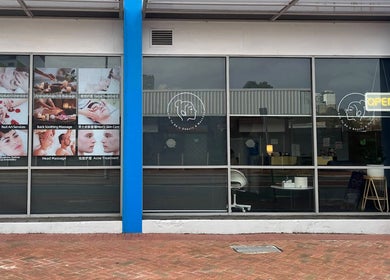 Exterior of Soft Sounds Massage in Perth, Western Australia, AU with service posters showcasing various treatments.