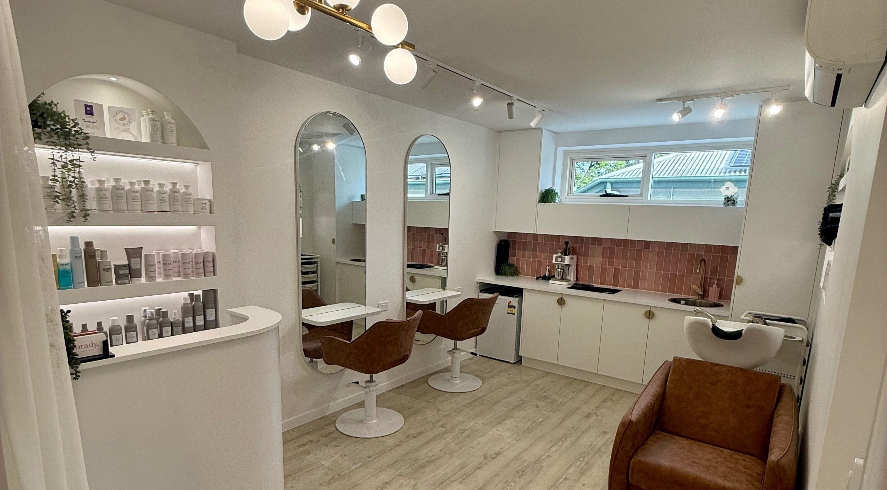 Elegant interior of Sorella Bella.Hair in Auchenflower, Queensland, AU showcasing chic styling stations and products.