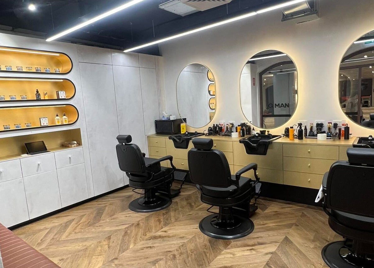 Modern barber interior at Quintessential Man, Redfern, New South Wales, AU with stylish chairs and mirrors.
