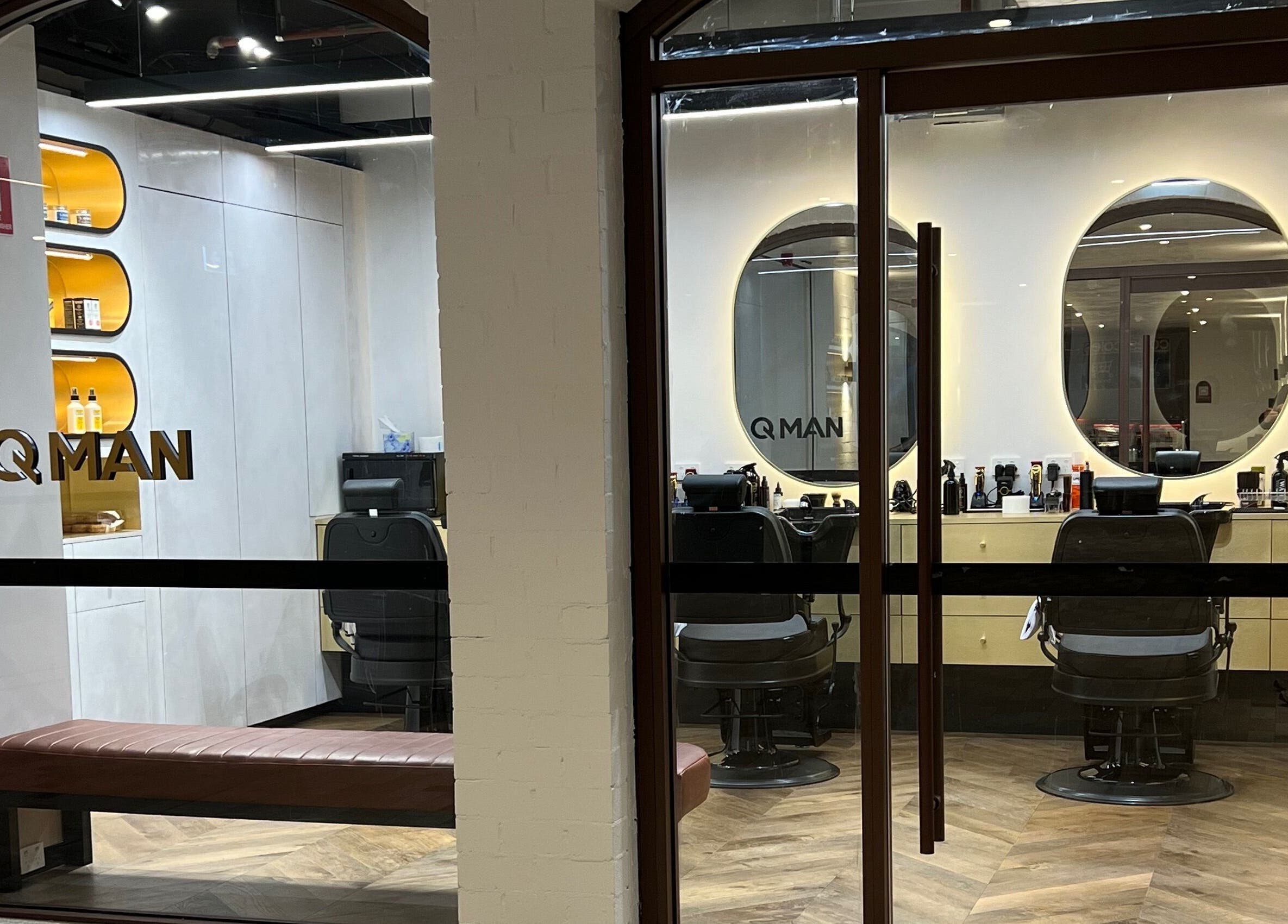 Sleek interior of Quintessential Man barbershop in Redfern, NSW, showcasing modern decor and stylish seating.