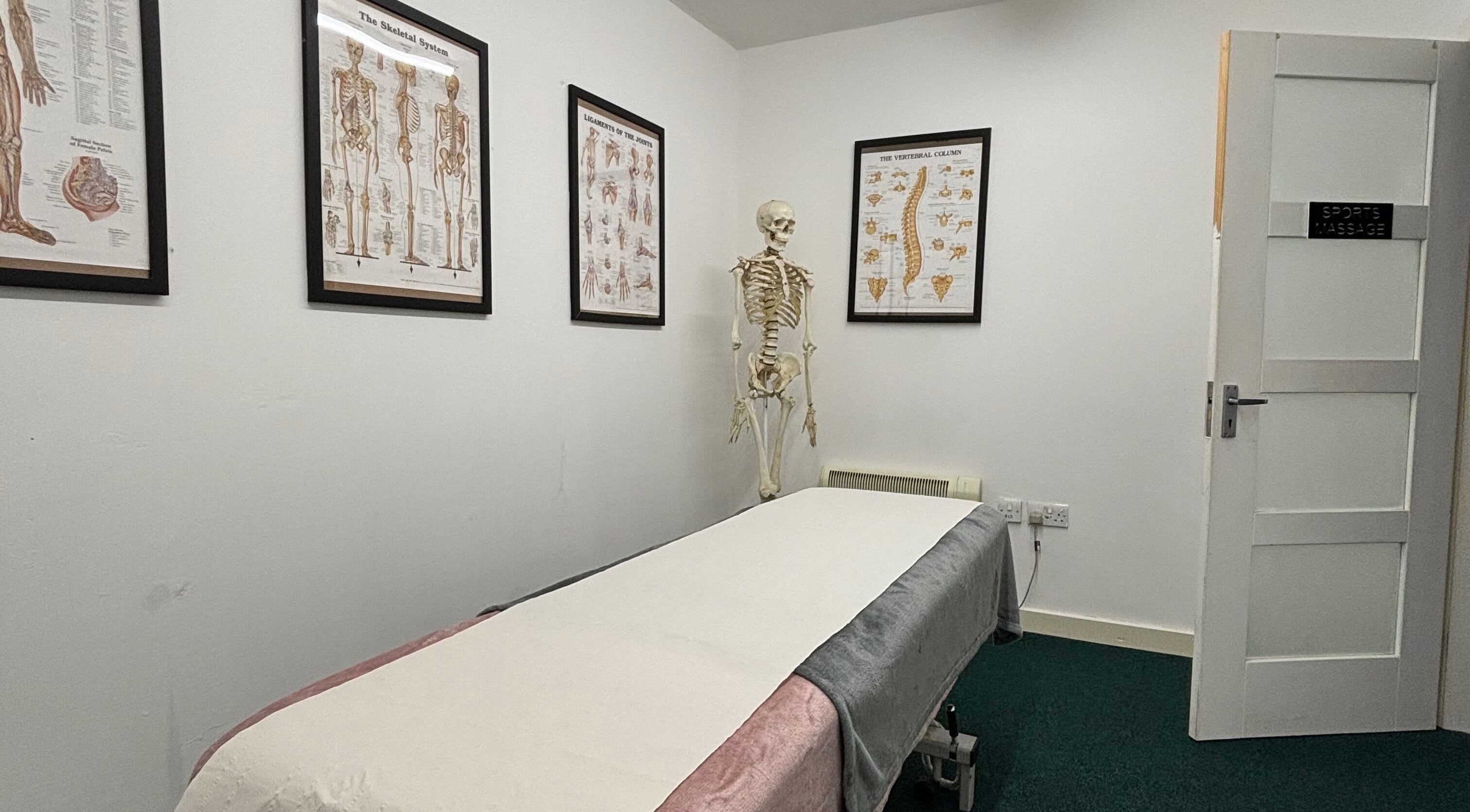 Massage room at Revive | Sports Therapy, Massage & Fitness, Liverpool, England, GB with anatomical posters.