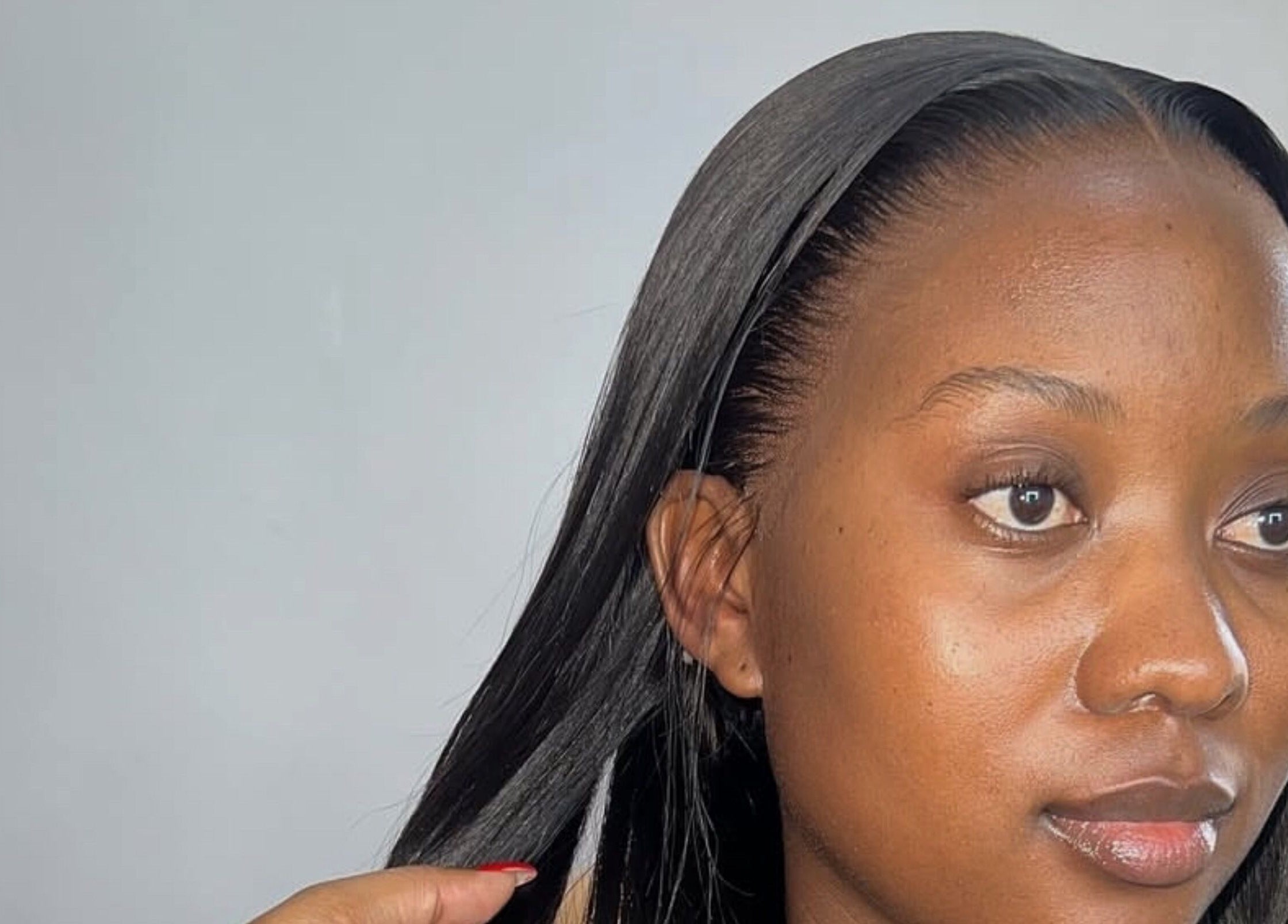 Woman with sleek hairstyle at KKTC BEAUTY SALOON, Randburg, Gauteng, ZA.