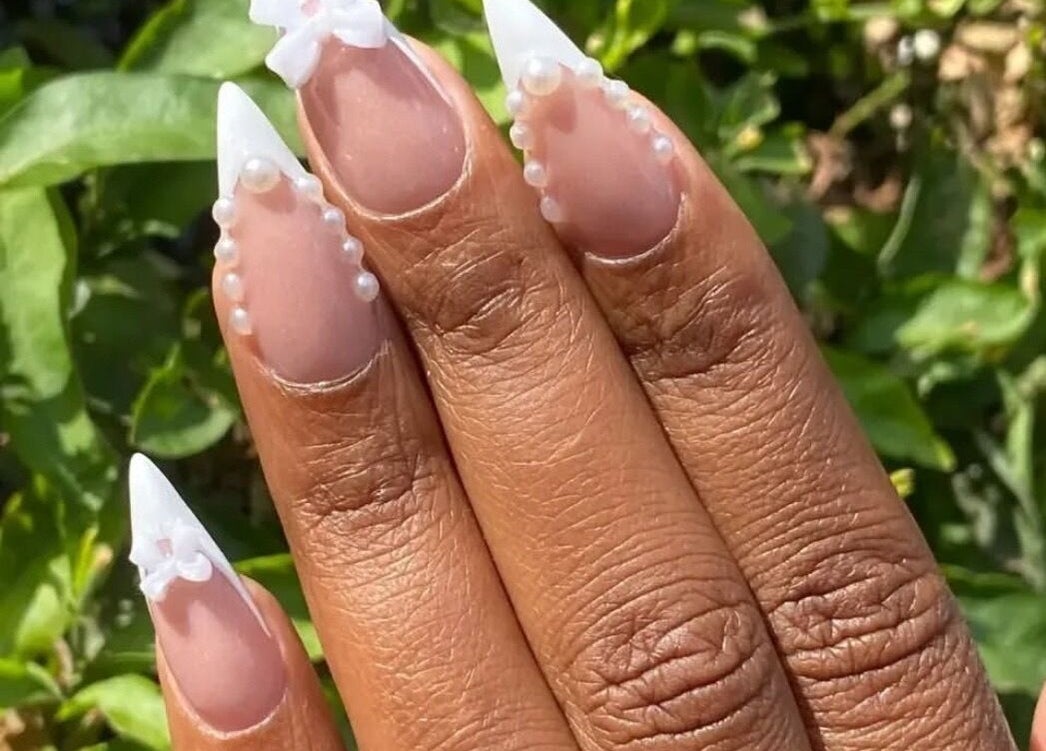 Elegant pearl-accented nail art at KKTC BEAUTY SALOON, Randburg, Gauteng, ZA, showcasing intricate design.