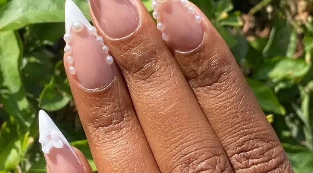 Elegant pearl-accented nail art at KKTC BEAUTY SALOON, Randburg, Gauteng, ZA, showcasing intricate design.