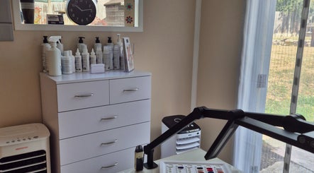 Modern interior of Fingers and Toes in Mexborough, England, GB with beauty products on display.
