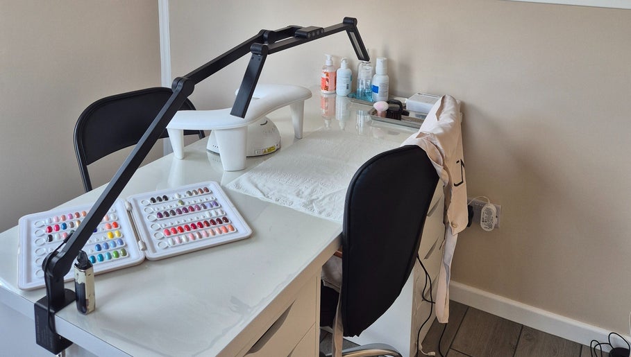 Manicure station at Fingers and Toes, Mexborough, England, GB, featuring nail polish samples and tools.